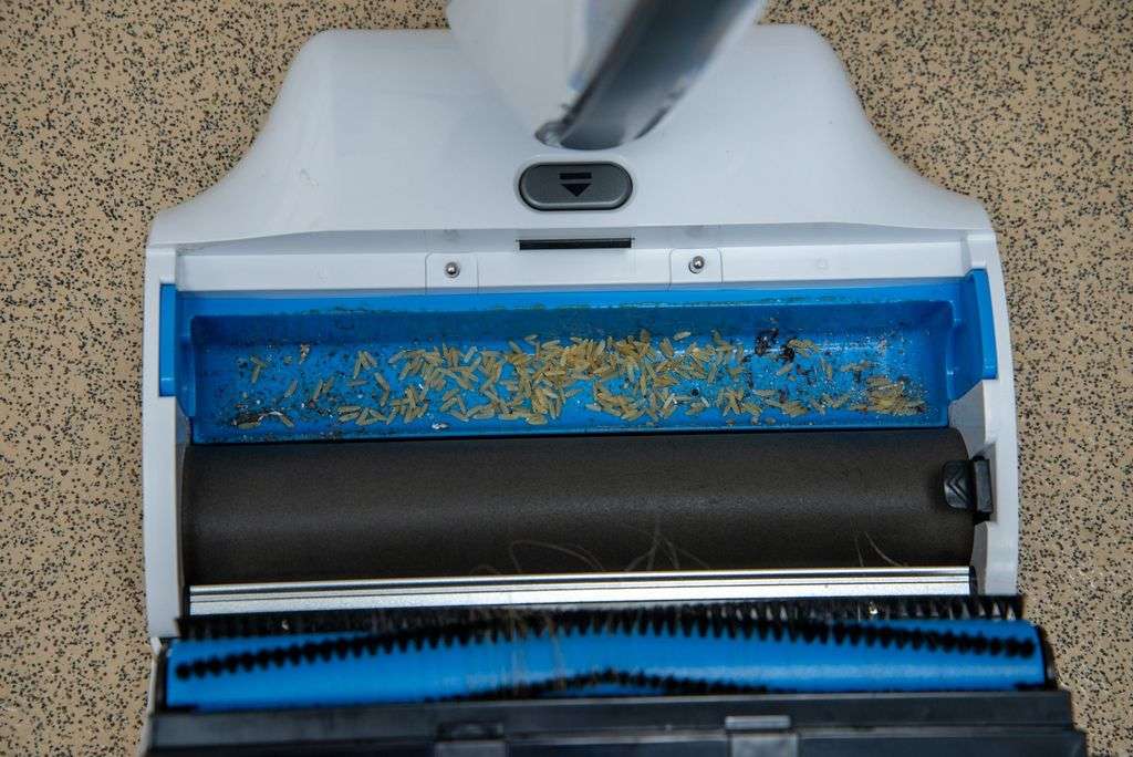 A close up of a vacuum cleaner with dust on it.